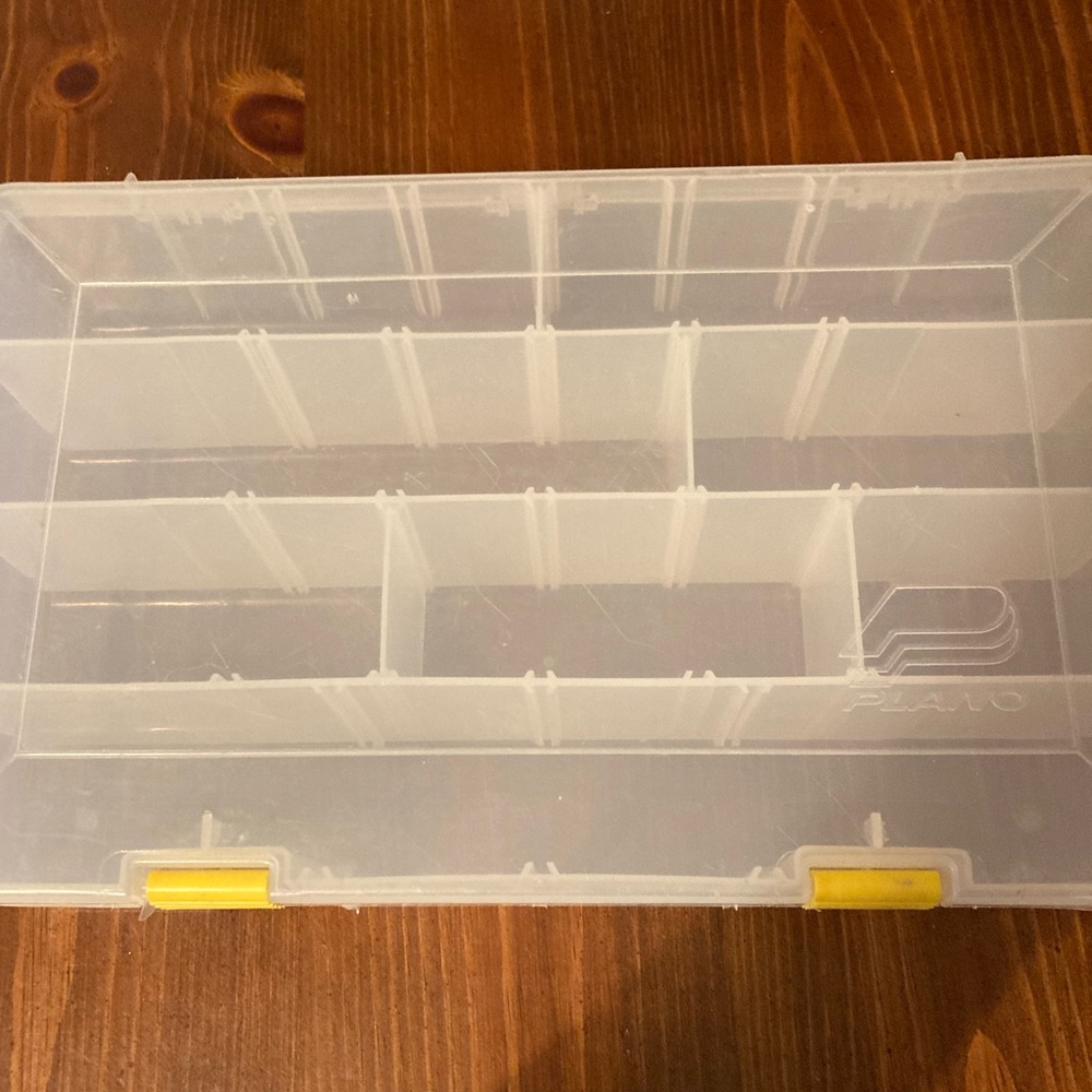 A plastic container with plastic tabs you can take out & make it bigger
